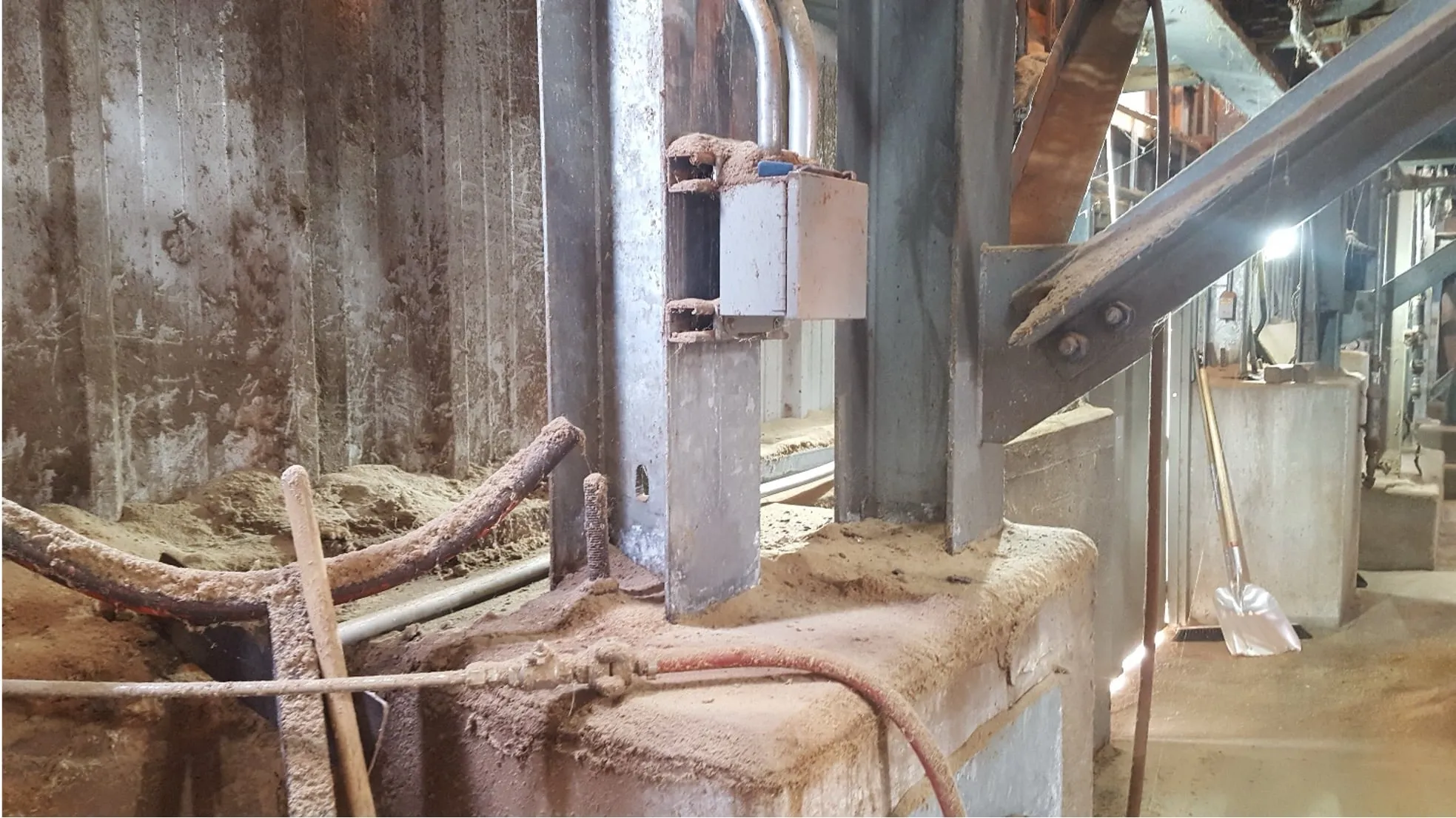 Dust accumulated on a junction box, beam and ledges inside a processing facility